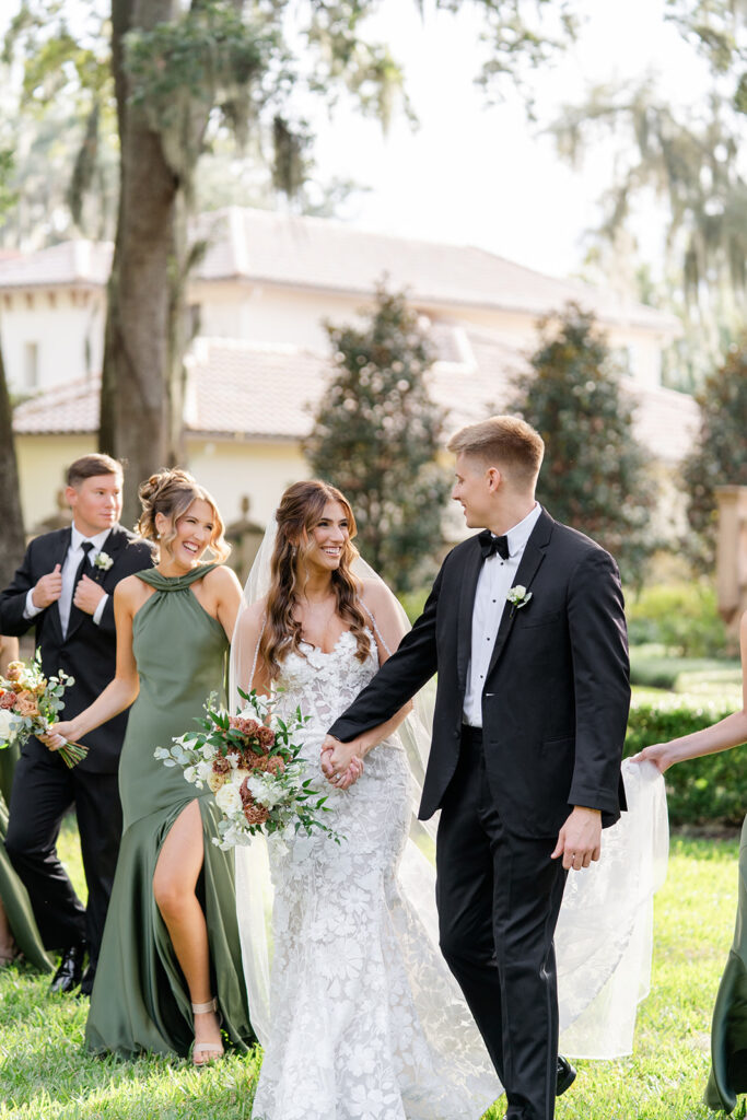 bride and groom hold hands during an outdoor wedding ceremony at Epping Forest Yacht Club in Jacksonville, Florida, captured by Snapshots by Gabriela
