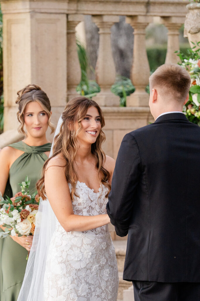 bride and groom hold hands during an outdoor wedding ceremony at Epping Forest Yacht Club in Jacksonville, Florida, captured by Snapshots by Gabriela