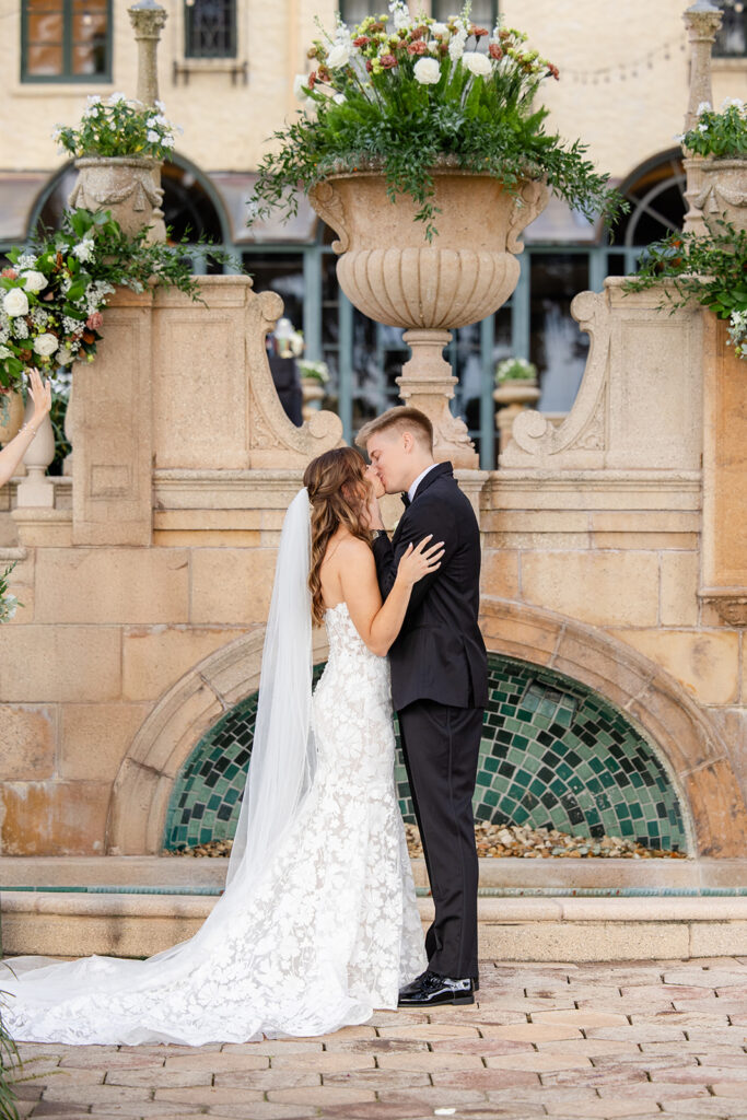 bride and groom kiss during an outdoor wedding ceremony at Epping Forest Yacht Club in Jacksonville, Florida, captured by Snapshots by Gabriela