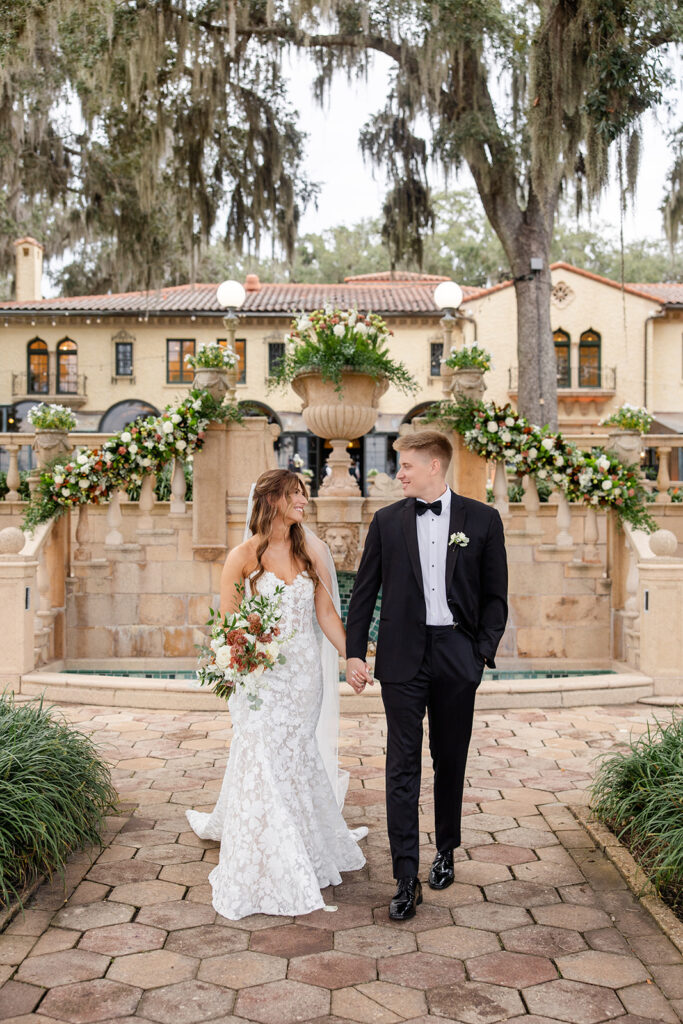 bride and groom couple portraits in front of the fountain at Epping Forest Yacht Club in Jacksonville, Florida, captured by Snapshots by Gabriela