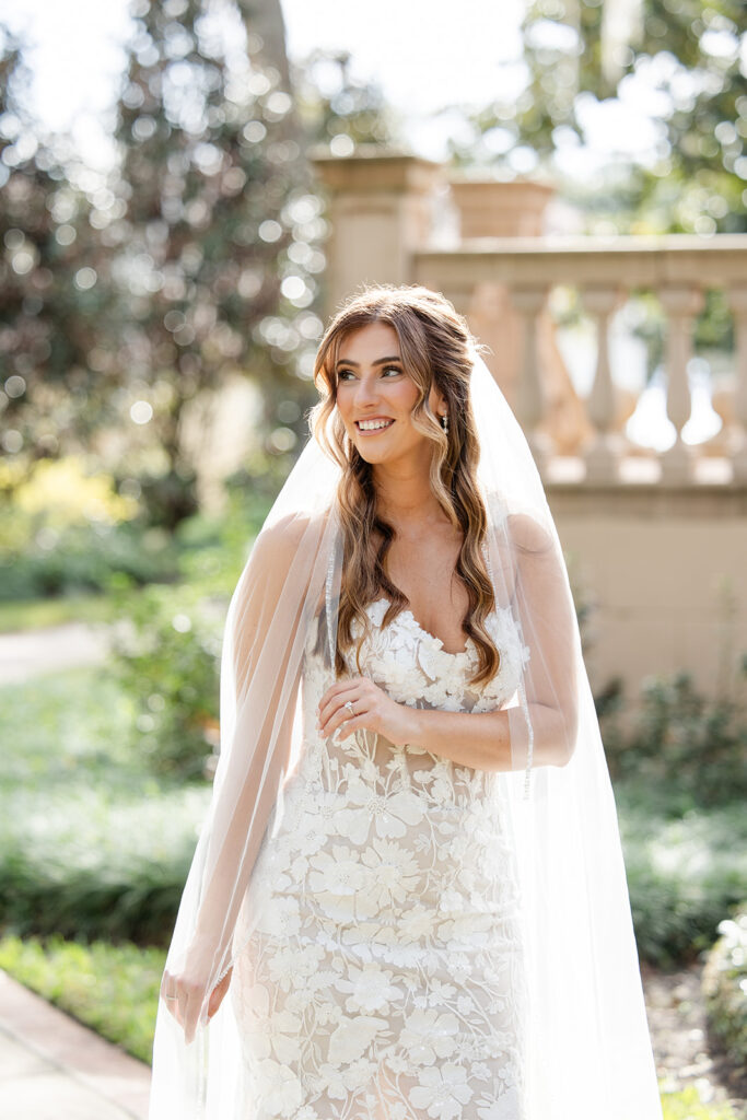 bride portrait with flowing veil in front of the outdoor stone staircase at Epping Forest Yacht Club in Jacksonville, Florida, captured by Snapshots by Gabriela