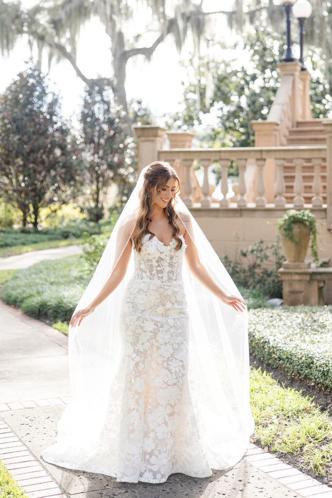 bride portrait with flowing veil in front of the outdoor stone staircase at Epping Forest Yacht Club in Jacksonville, Florida, captured by Snapshots by Gabriela