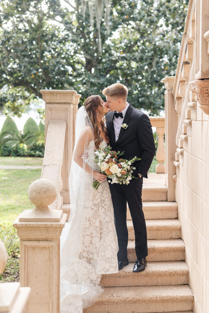 bride and groom couple portraits in front of the outdoor stone staircase at Epping Forest Yacht Club in Jacksonville, Florida, captured by Snapshots by Gabriela