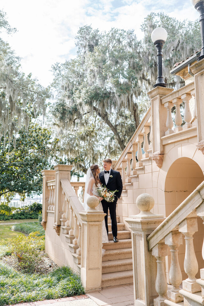 bride and groom couple portraits in front of the outdoor stone staircase at Epping Forest Yacht Club in Jacksonville, Florida, captured by Snapshots by Gabriela