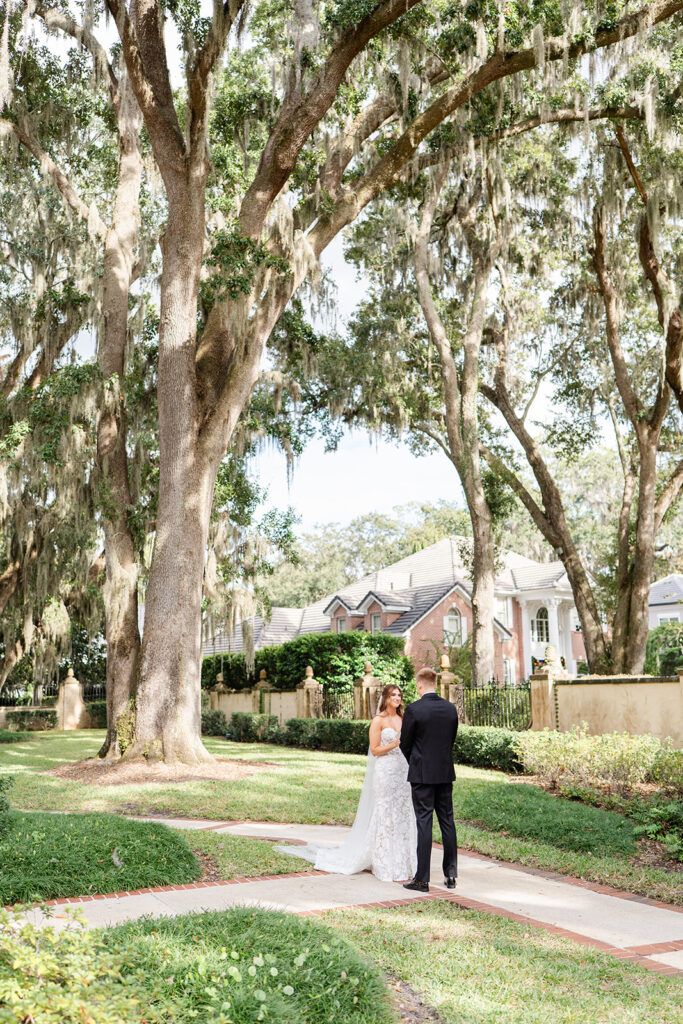 bride and groom first look in front of the outdoor staircase at Epping Forest Yacht Club in Jacksonville, Florida, captured by Snapshots by Gabriela