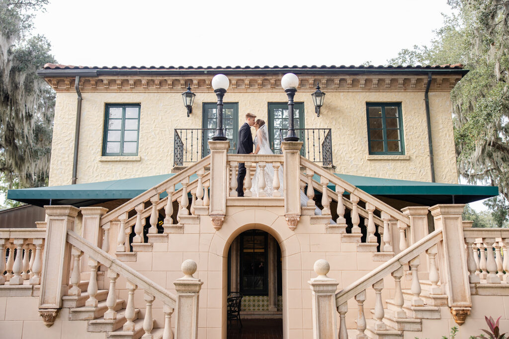 bride and groom couple portraits in front of the outdoor stone staircase at Epping Forest Yacht Club in Jacksonville, Florida, captured by Snapshots by Gabriela