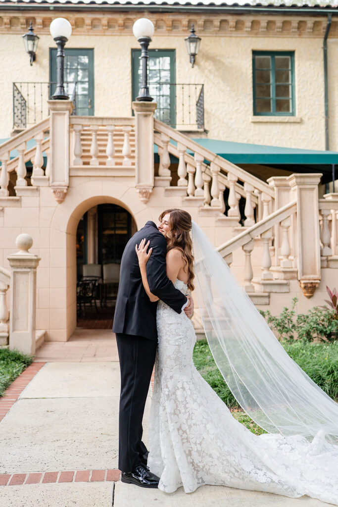 bride and groom first look in front of the outdoor staircase at Epping Forest Yacht Club in Jacksonville, Florida, captured by Snapshots by Gabriela