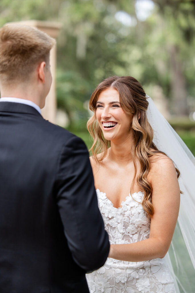 bride and groom first look in front of the outdoor staircase at Epping Forest Yacht Club in Jacksonville, Florida, captured by Snapshots by Gabriela