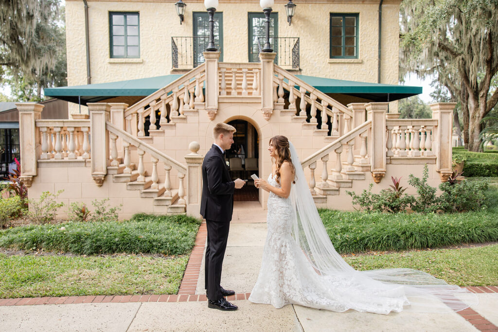bride and groom first look in front of the outdoor staircase at Epping Forest Yacht Club in Jacksonville, Florida, captured by Snapshots by Gabriela