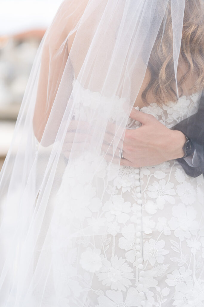 bride and groom posing in front of a river at Epping Forest Yacht Club in Jacksonville, Florida, captured by Snapshots by Gabriela
