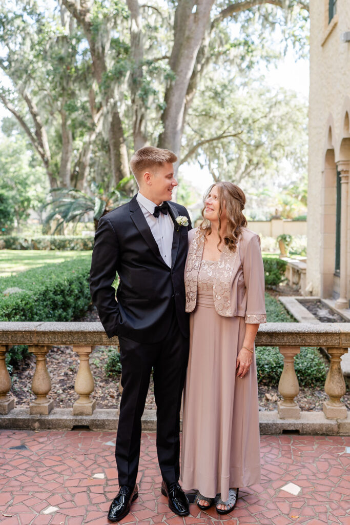 groom standing with his mother outside Epping Forest Yacht Club in Jacksonville, Florida, captured by Snapshots by Gabriela