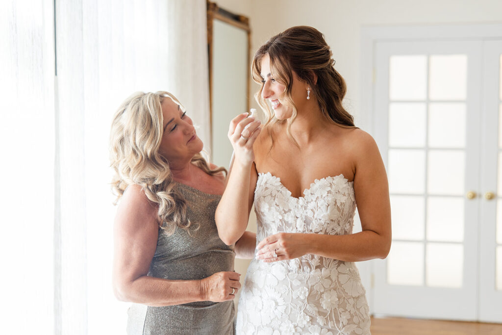 bride in lace dress with her mother at Epping Forest Yacht Club in Jacksonville, Florida, captured by Snapshots by Gabriela