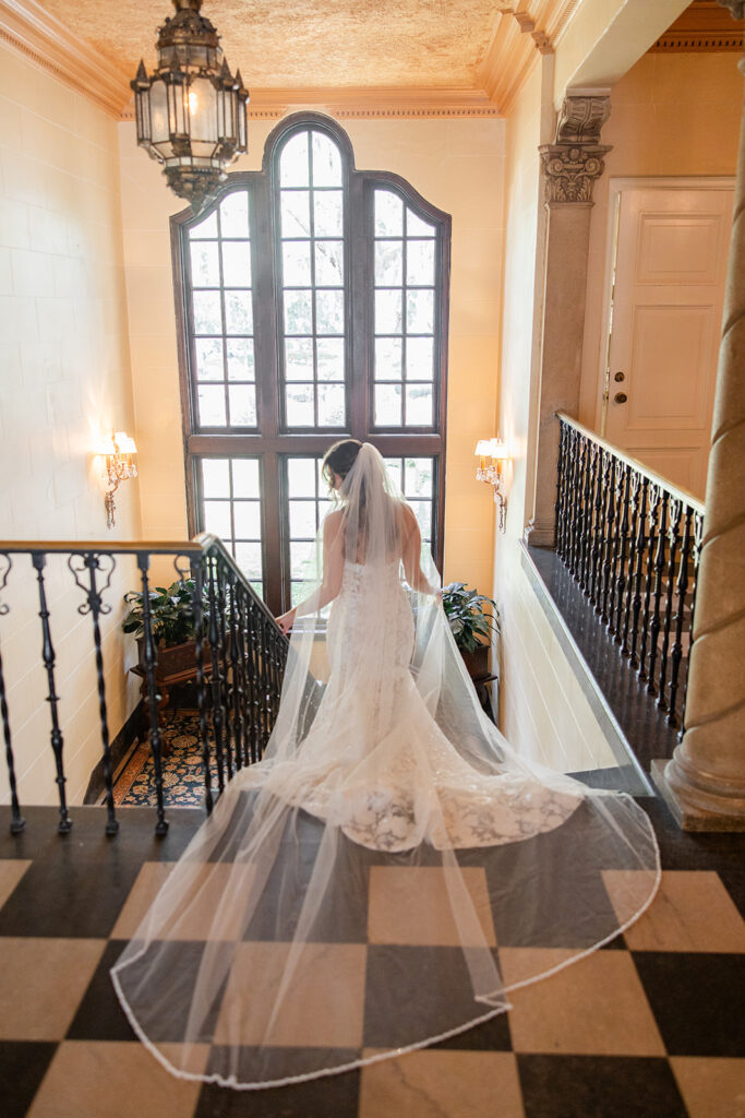 bride in lace dress with a flowing floor-length veil at Epping Forest Yacht Club in Jacksonville, Florida, captured by Snapshots by Gabriela