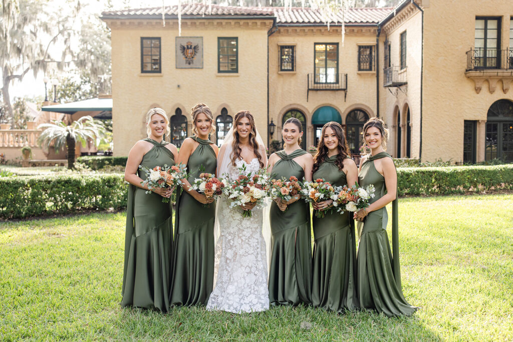 Wedding party portrait with bridesmaids in green and bride in white at Epping Forest Yacht Club in Jacksonville, Florida, captured by Snapshots by Gabriela