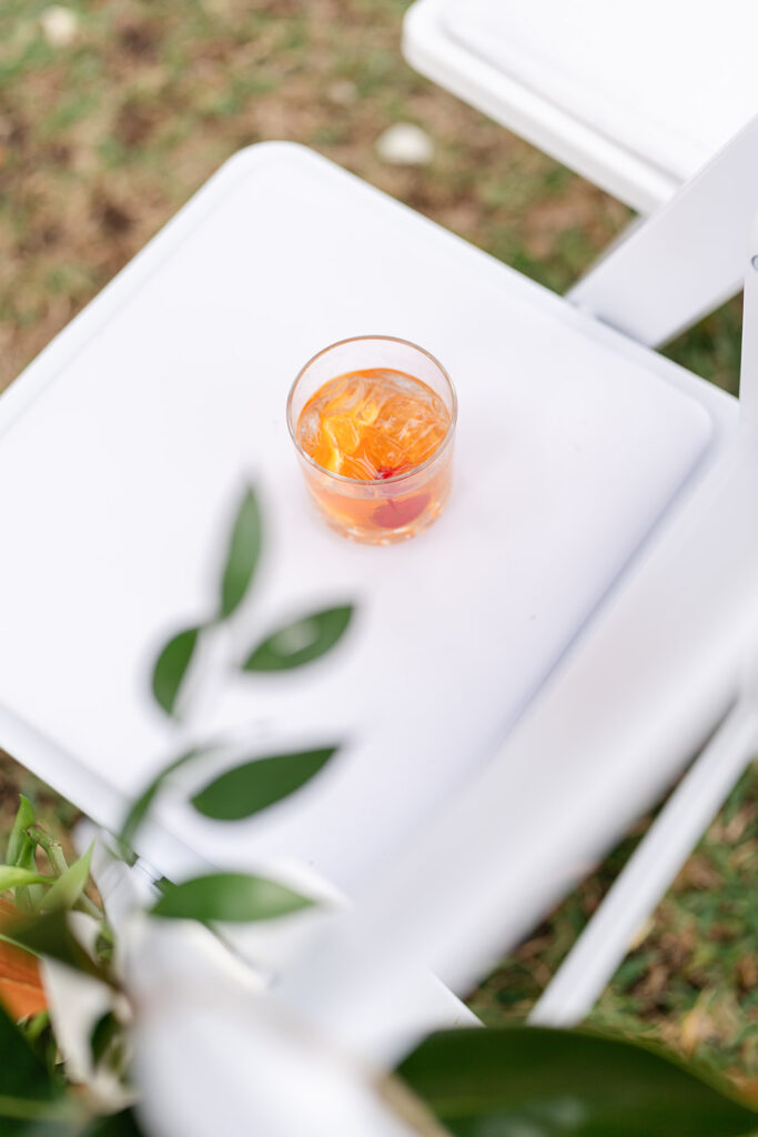 cocktail on a chair at an outdoor wedding reception at Epping Forest Yacht Club in Jacksonville, Florida, captured by Snapshots by Gabriela