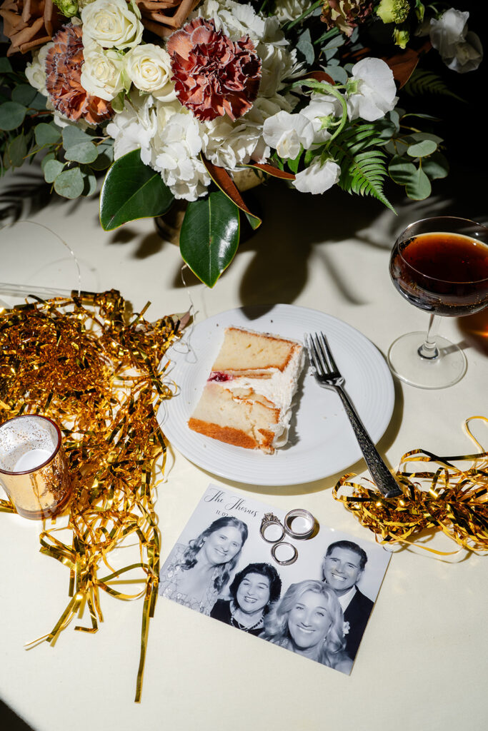 late-night wedding table with cake, a photo and an espresso martini at an outdoor wedding reception at Epping Forest Yacht Club in Jacksonville, Florida, captured by Snapshots by Gabriela