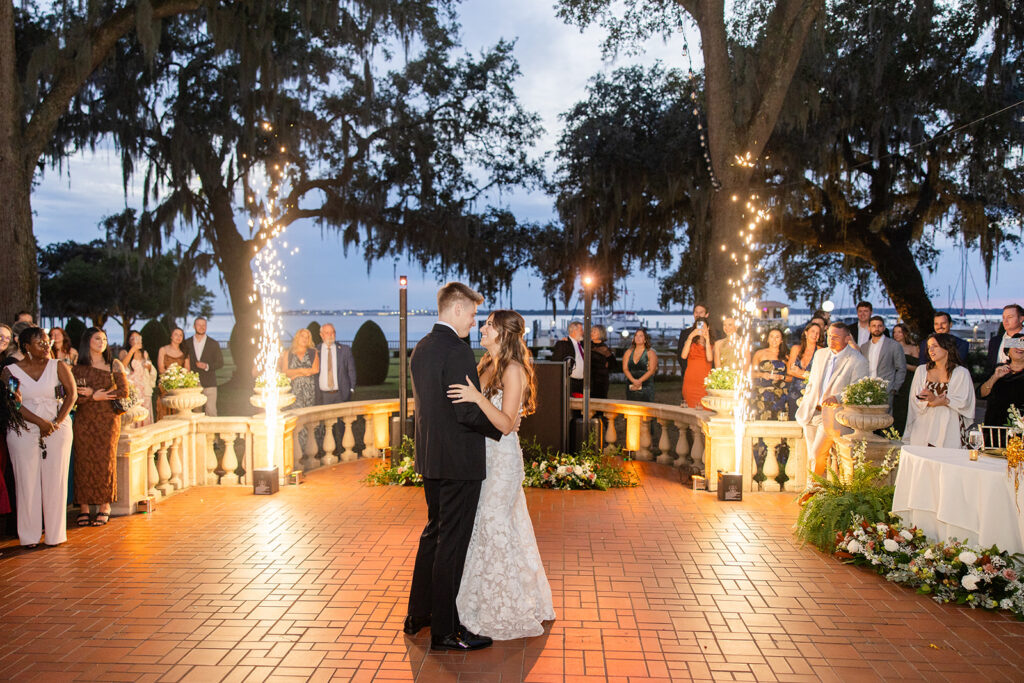 bride and groom first dance on the terrace at an outdoor wedding reception at Epping Forest Yacht Club in Jacksonville, Florida, captured by Snapshots by Gabriela