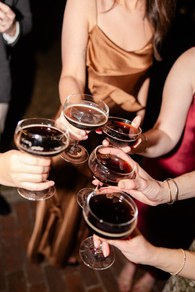 women's hands holding espresso martinis at an outdoor wedding reception at Epping Forest Yacht Club in Jacksonville, Florida, captured by Snapshots by Gabriela