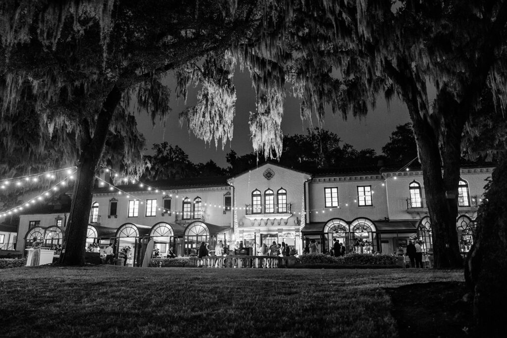 black and white outdoor shot of the lawn with string lights at an outdoor wedding reception at Epping Forest Yacht Club in Jacksonville, Florida, captured by Snapshots by Gabriela
