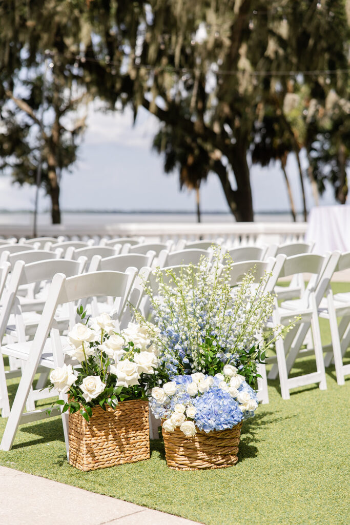 outdoor ceremy setup with white folding chairs on the lawn at Bella Cosa Lakeside in Lake Wales Florida