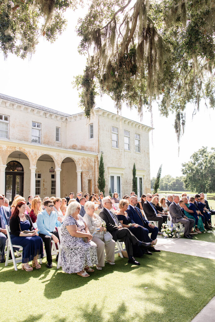 outdoor wedding ceremony on the lawn at Bella Cosa Lakeside in Lake Wales Florida