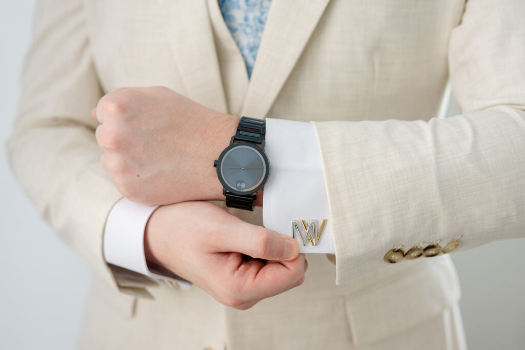 groom's hand wearing a black watch and custom cuff links at a wedding at Bella Cosa Lakeside in Lake Wales Florida