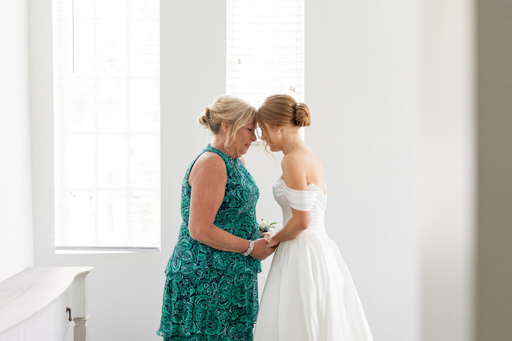 bride and her mother touching foreheads at a wedding at Bella Cosa Lakeside in Lake Wales Florida