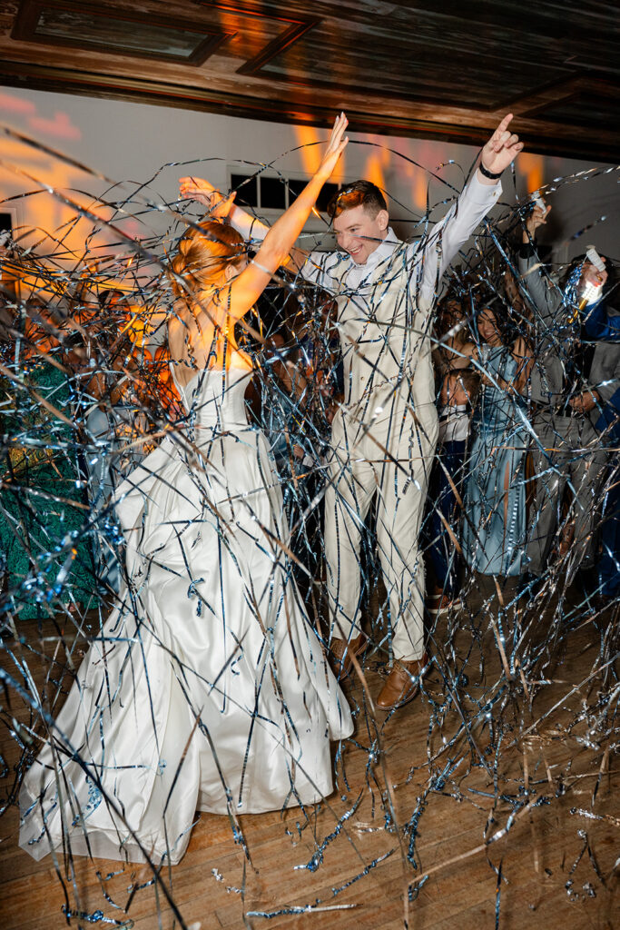 bride and groom dance amidst metallic streamers at a wedding reception at Bella Cosa Lakeside in Lake Wales Florida