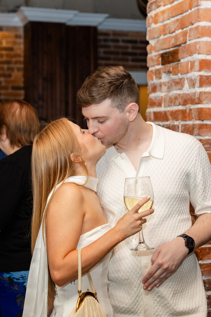 bride and groom kiss at their rehearsal dinner near Bella Cosa Lakeside in Lake Wales Florida