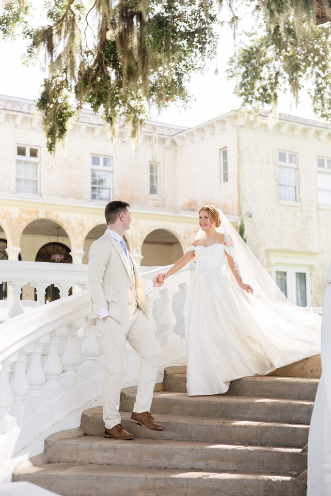 bride and groom portrait on the steps on the lawn at a wedding at Bella Cosa Lakeside in Lake Wales Florida