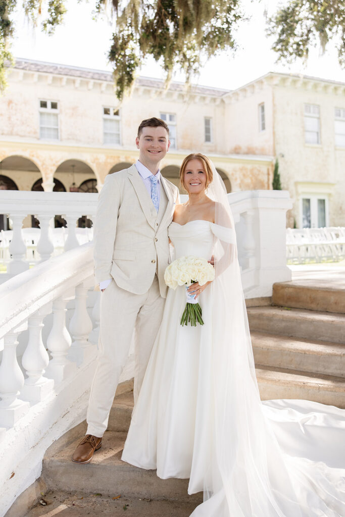bride and groom portrait on the steps on the lawn at a wedding at Bella Cosa Lakeside in Lake Wales Florida