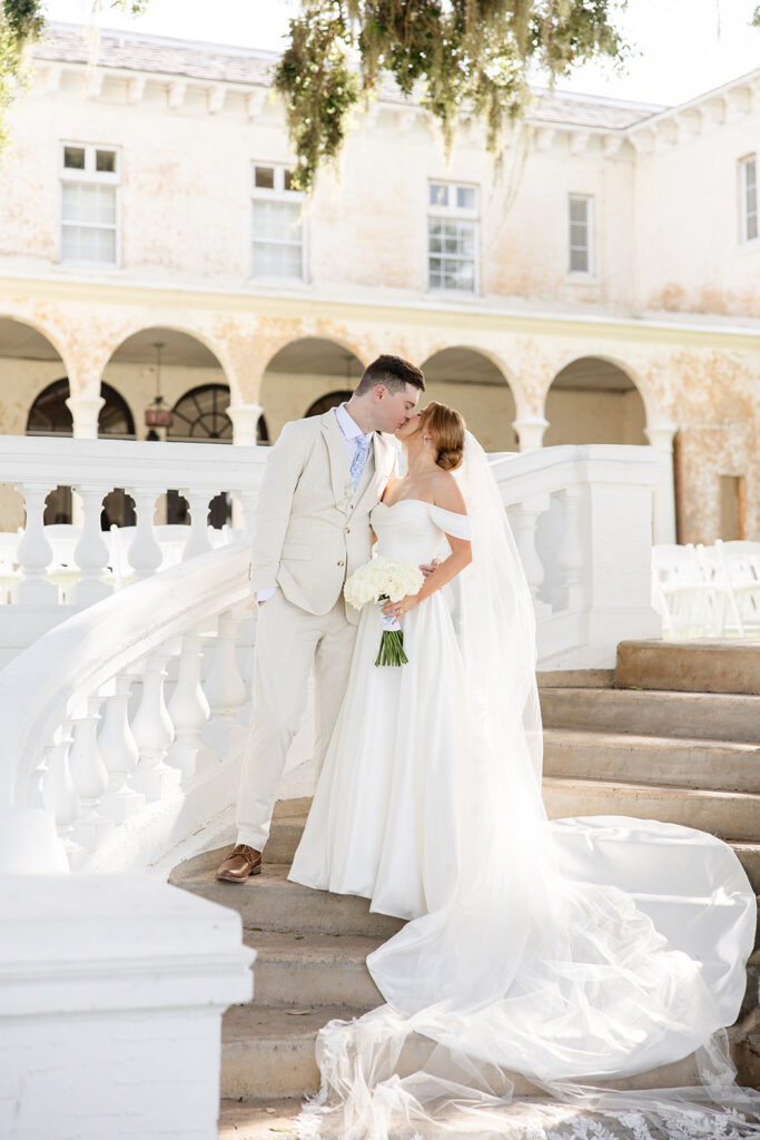 bride and groom portrait on the steps on the lawn at a wedding at Bella Cosa Lakeside in Lake Wales Florida