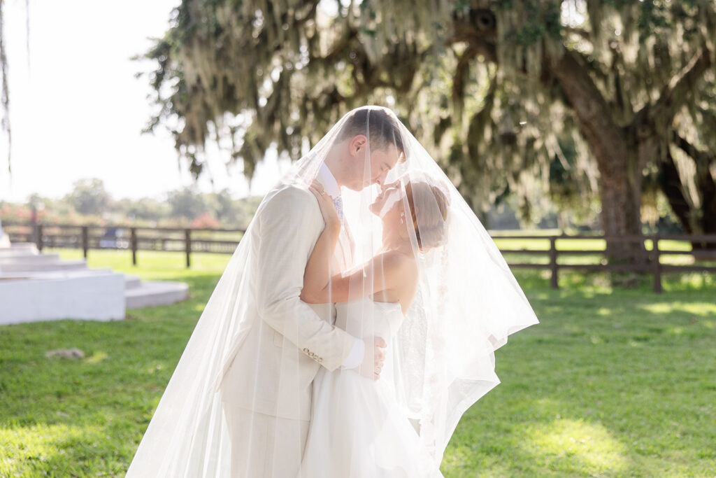bride and groom portrait under her veil at a wedding at Bella Cosa Lakeside in Lake Wales Florida