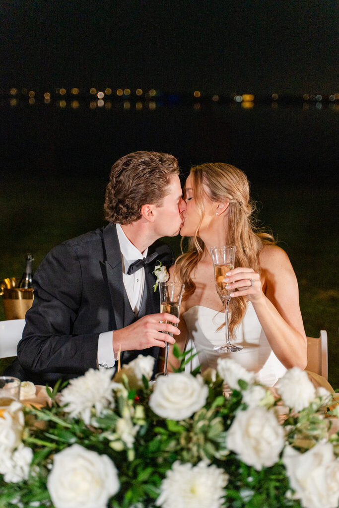 bride and groom kiss at an outdoor wedding reception at Adams Estate in Lake Alfred, Florida, captured by Snapshots by Gabriela