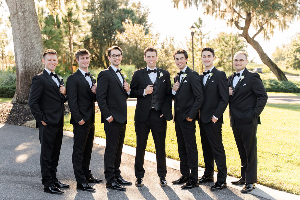 groom with groomsmen in black tuxedos at an outdoor wedding at Adams Estate in Lake Alfred, Florida, captured by Snapshots by Gabriela