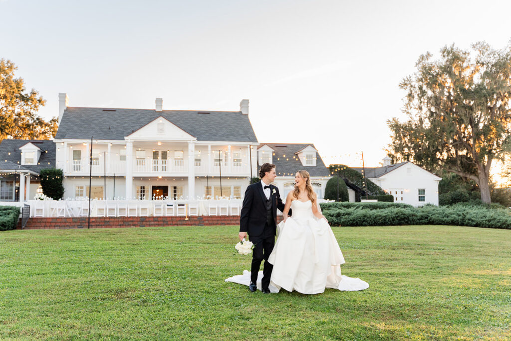 Bride and groom in front of the mansion at an outdoor wedding at Adams Estate in Lake Alfred, Florida, captured by Snapshots by Gabriela