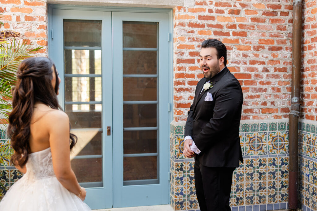 bride and groom first look at historic estate wedding venue Casa Feliz in Winter Park, Florida, photographed by Snapshots by Gabriela