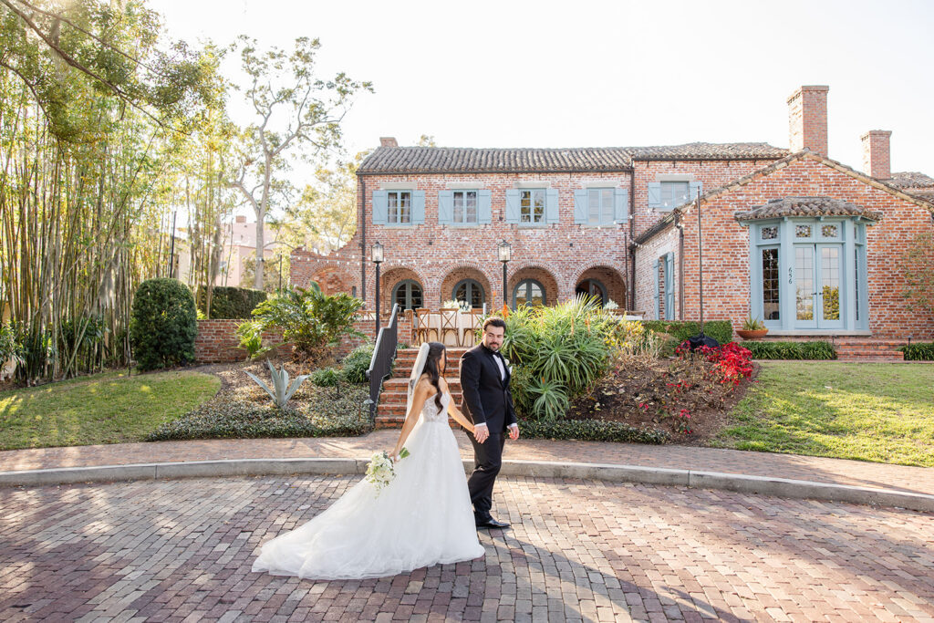 bride and groom stand in front of Casa Feliz in Winter Park, Florida, photographed by Snapshots by Gabriela