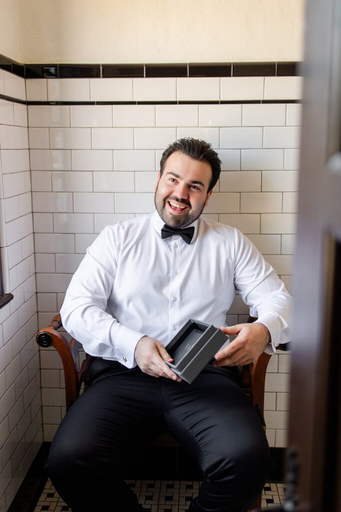 groom getting dressed at historic estate wedding venue Casa Feliz in Winter Park, Florida, photographed by Snapshots by Gabriela