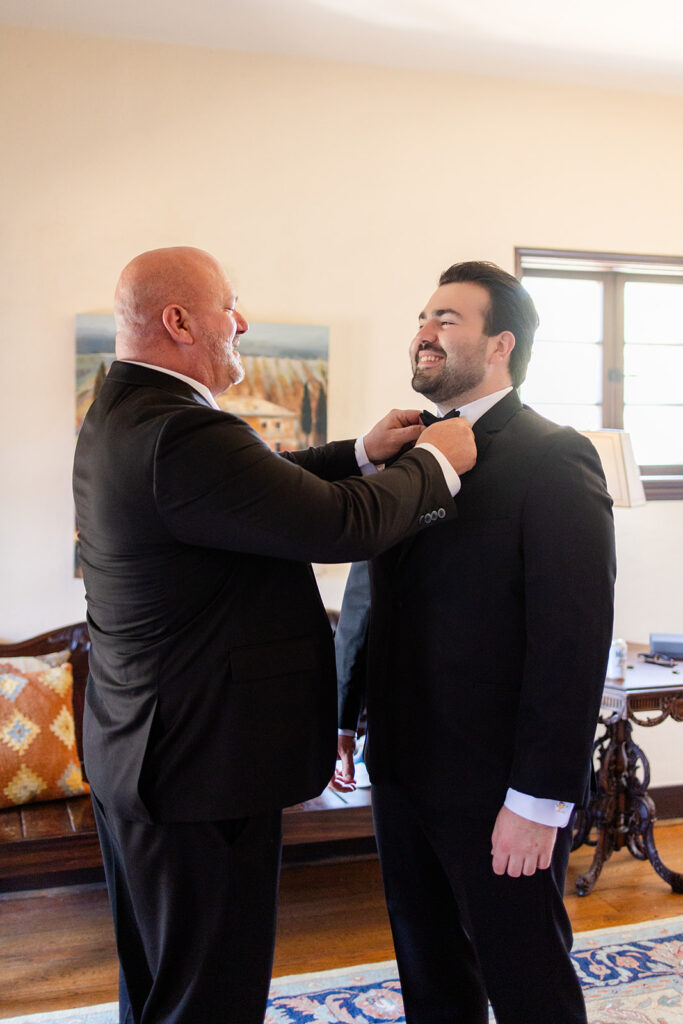 groom getting dressed at historic estate wedding venue Casa Feliz in Winter Park, Florida, photographed by Snapshots by Gabriela