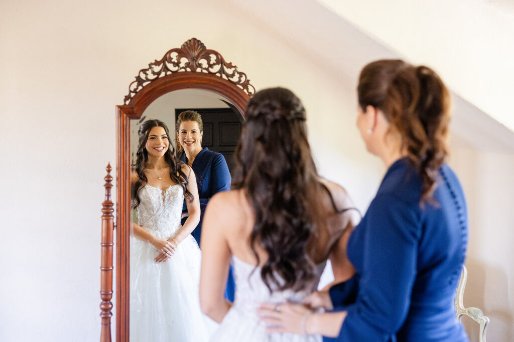 bride getting dressed at historic estate wedding venue Casa Feliz in Winter Park, Florida, photographed by Snapshots by Gabriela