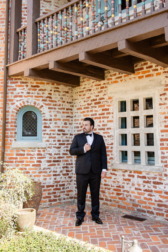 groom getting dressed at historic estate wedding venue Casa Feliz in Winter Park, Florida, photographed by Snapshots by Gabriela