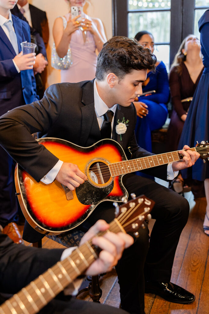 man playing guitar at historic estate wedding venue Casa Feliz in Winter Park, Florida, photographed by Snapshots by Gabriela