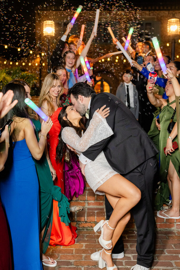 bride and groom kissing during their bubble exit at historic estate wedding venue Casa Feliz in Winter Park, Florida, photographed by Snapshots by Gabriela