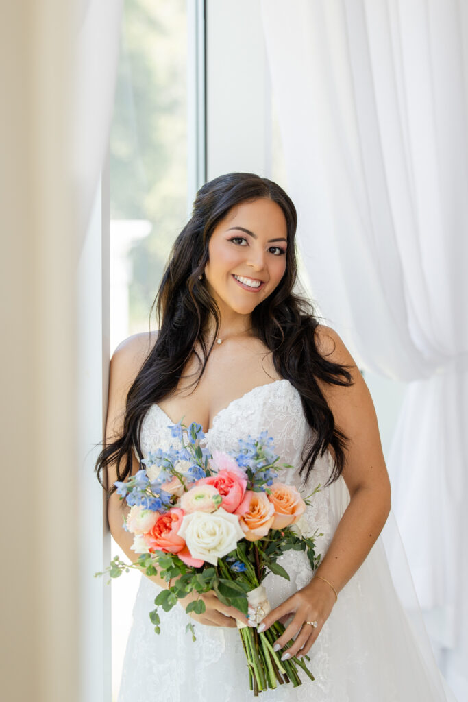 bride holding a bright spring bouquet at a wedding at Lake Mary Events Center, captured by Snapshots by Gabriela