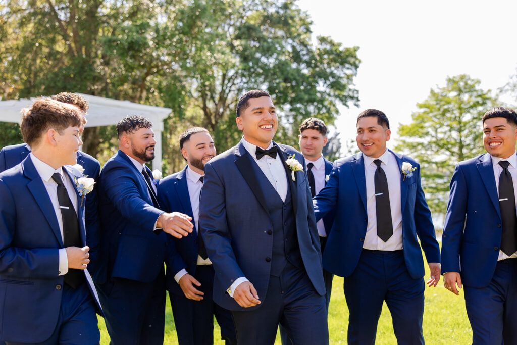 groom and groomsmen wearing navy suits at a spring wedding at Lake Mary Events Center, captured by Snapshots by Gabriela