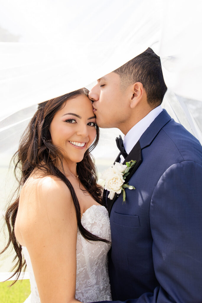 bride and groom outdoor portrait under bride's veil at a spring wedding at Lake Mary Events Center, captured by Snapshots by Gabriela