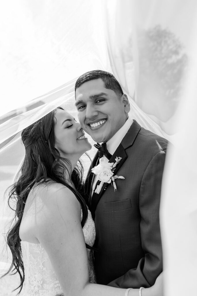 bride and groom outdoor portrait under bride's veil at a spring wedding at Lake Mary Events Center, captured by Snapshots by Gabriela