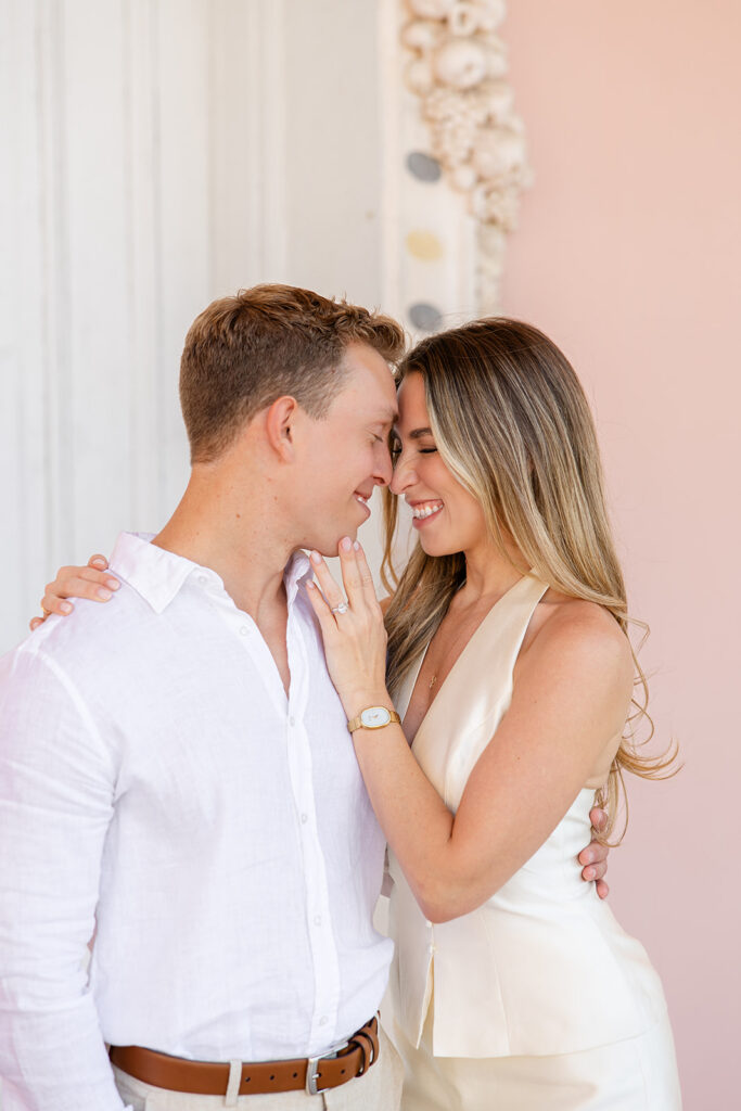 Woman in white mini-dress and man in white shirt and khaki pants at The Ringling Museum in Sarasota for their engagement photos captured by Snapshots by Gabriela