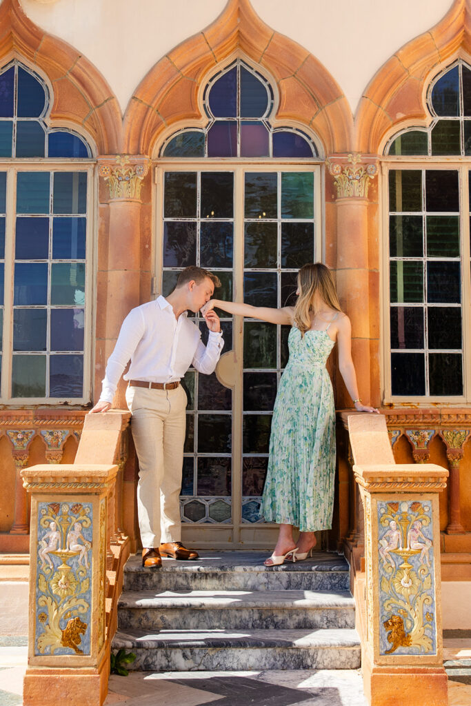 Woman in green floral dress and man in white shirt and khaki pants at The Ringling Museum in Sarasota for their engagement photos captured by Snapshots by Gabriela